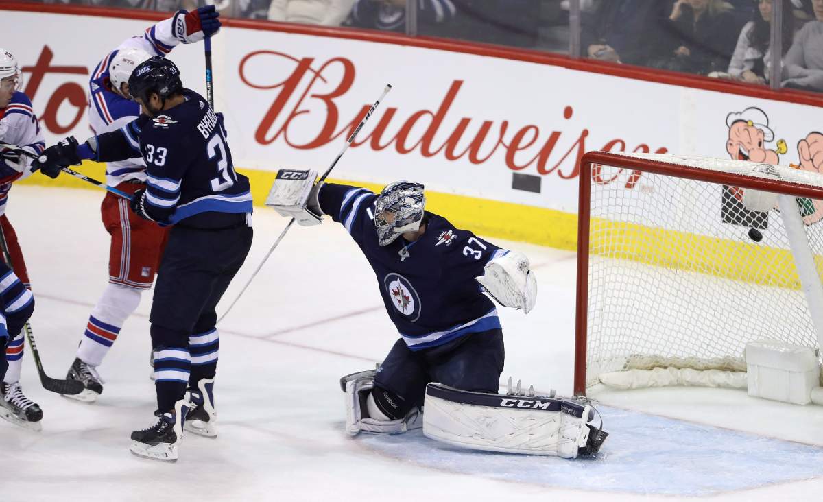 New York Rangers' Jimmy Vesey (not shown) scores on Winnipeg Jets goaltender Connor Hellebuyck (37) during third period NHL hockey action in Winnipeg, Sunday, February 11, 2018. THE CANADIAN PRESS/Trevor Hagan.