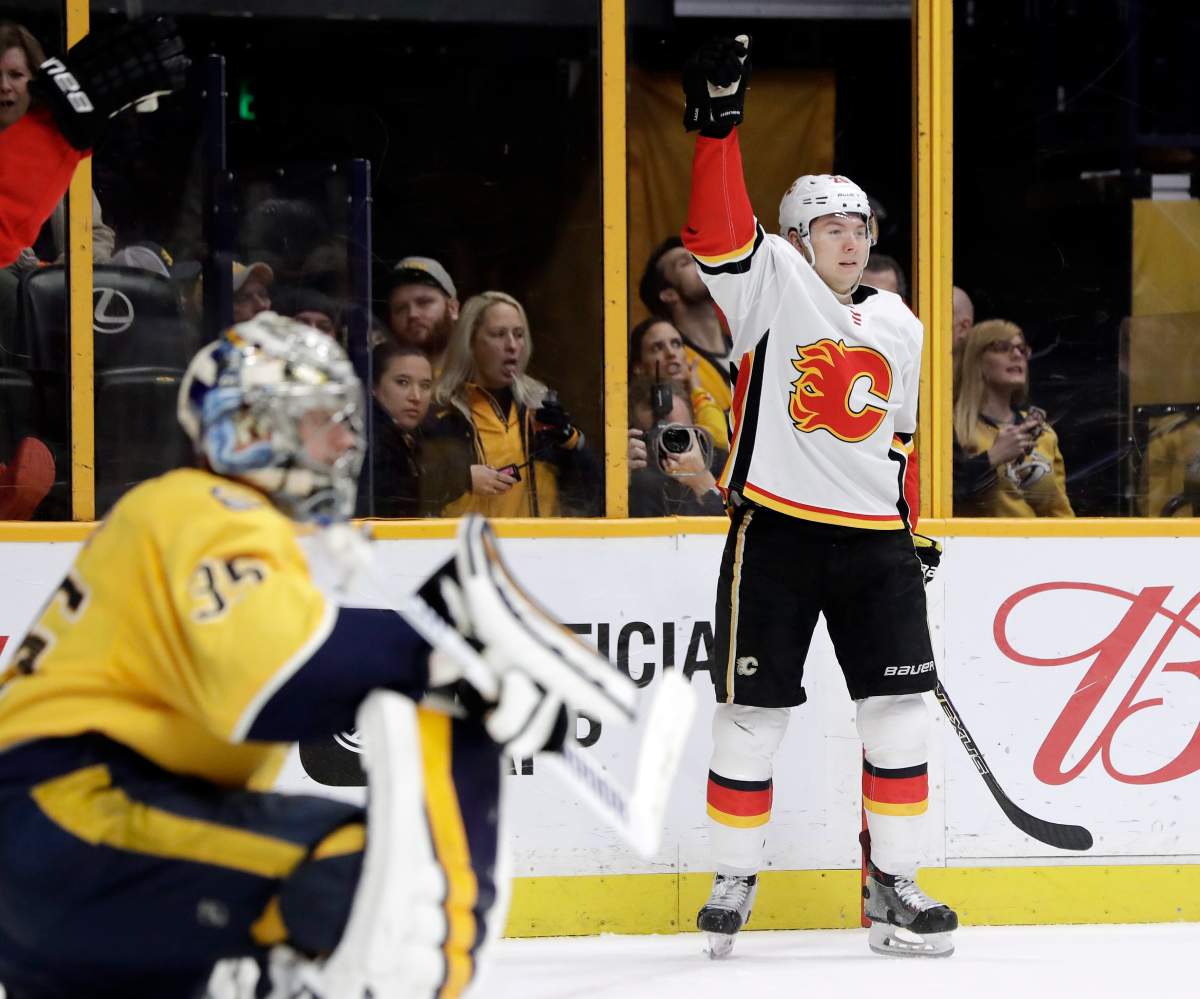 Calgary Flames center Curtis Lazar, right, celebrates after scoring a goal against Nashville Predators goalie Pekka Rinne (35), of Finland, in the third period of an NHL hockey game Thursday, Feb. 15, 2018, in Nashville, Tenn. (AP Photo/Mark Humphrey).