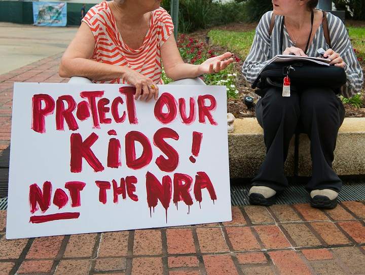 A woman holds a sign at the Florida state Capitol in Tallahassee, Florida, USA, 21 February 2018. Seventeen people were killed by a gunman at Marjory Stoneman Douglas High School 14 February 2018, in Parkland, Florida. Students, parents and others are calling for legislative changes to gun access.