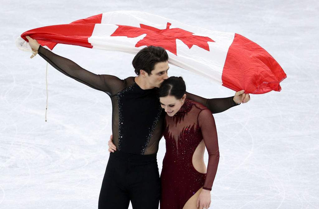 Tessa Virtue and Scott Moir of Canada celebrate the gold medal during the venue victory ceremony following the Figure Skating Ice Dance Free Dance program at the PyeongChang 2018 Winter Olympic Games on February 20, 2018.