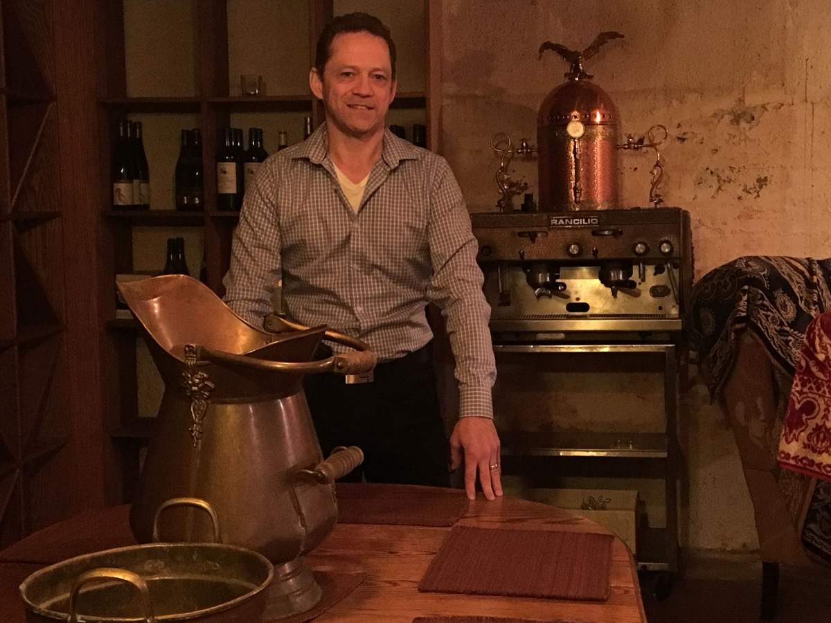Mike Comeau, owner of La Boheme, at the cellar table Wayne Gretzky and friends used to dine. La Boheme is shutting its doors on March 18, 2018.