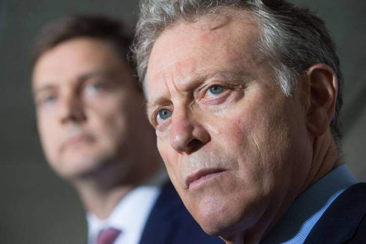 B.C. Environment Minister George Heyman, front, and Attorney General David Eby listen to a question during a news conference about the Kinder Morgan Trans Mountain pipeline expansion project, in Vancouver, B.C., on Thursday August 10, 2017.