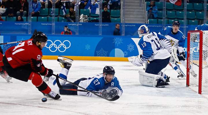 Linden Vey (L) of Canada gets blocked against Petri Kontiola (C) of Finland during the men's play-offs Quarterfinals match between Canada and Finland inside the Gangneung Hockey Centre at the PyeongChang Winter Olympic Games 2018, in Gangneung, South Korea, 21 February 2018.