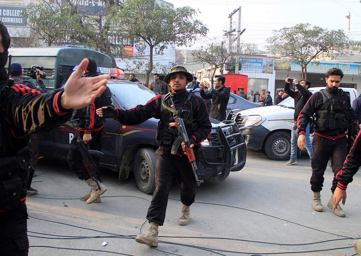 Police clear journalists out of the way for a police van carrying Imran Ali suspected to be a serial killer responsible for the rape and murder of a seven-year-old girl to the anti terrorism court in Lahore, Pakistan.