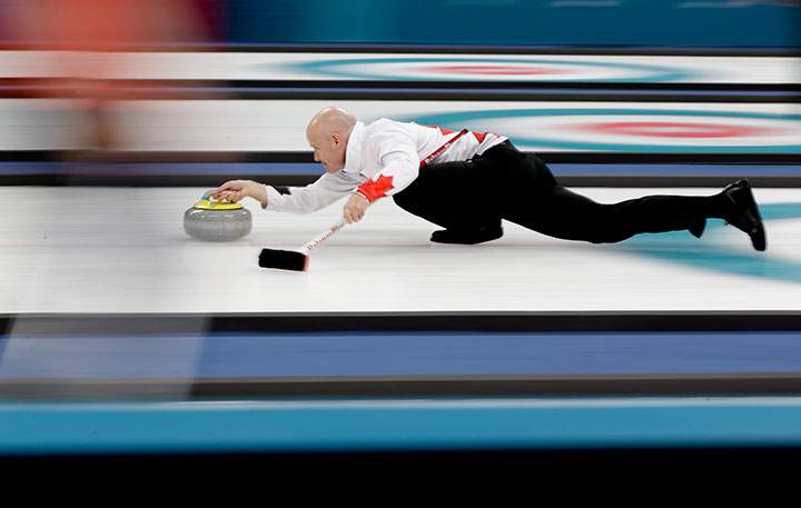 Canada’s skip Kevin Koe throws a stone during a men’s curling match against Japan at the 2018 Winter Olympics in Gangneung, South Korea, Feb. 20, 2018.