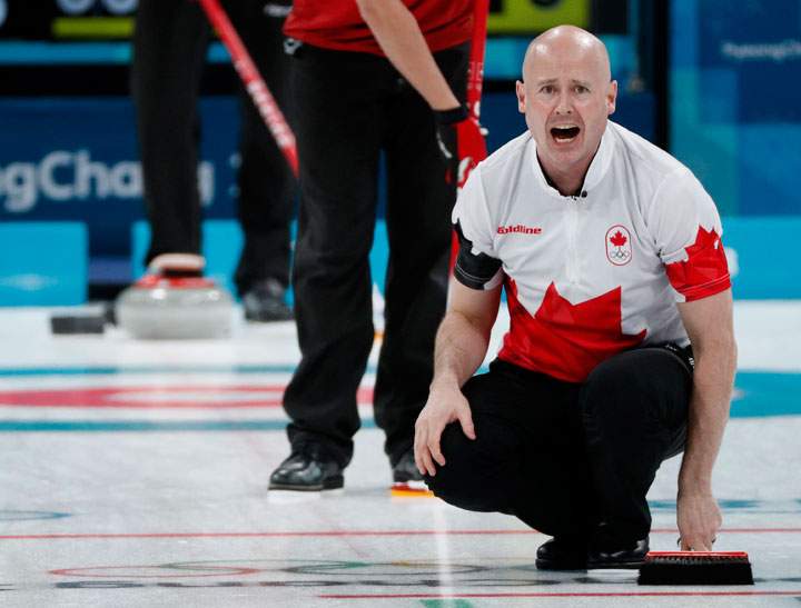 Skip Kevin Koe of Canada shouts at teammates. 