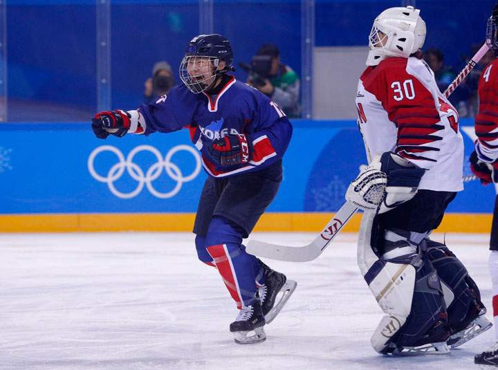 Kim Hee-won of Korea celebrates after Korea scores against goalkeeper Akane Konishi of Japan.
