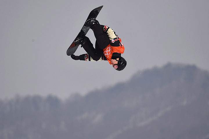 Canada's Max Parrot flies through the air during his second run in the men's snowboard slopestyle qualification at the Phoenix Snow Park at the 2018 Winter Olympic Games in Pyeongchang, South Korea, Feb. 10, 2018. 