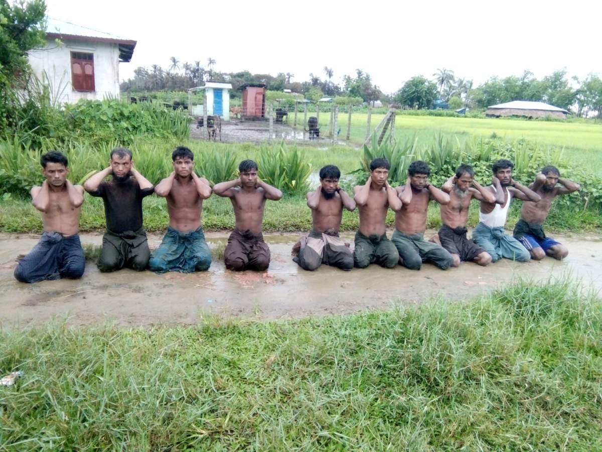 Ten Rohingya Muslim men with their hands bound kneel in Inn Din village September 1, 2017.