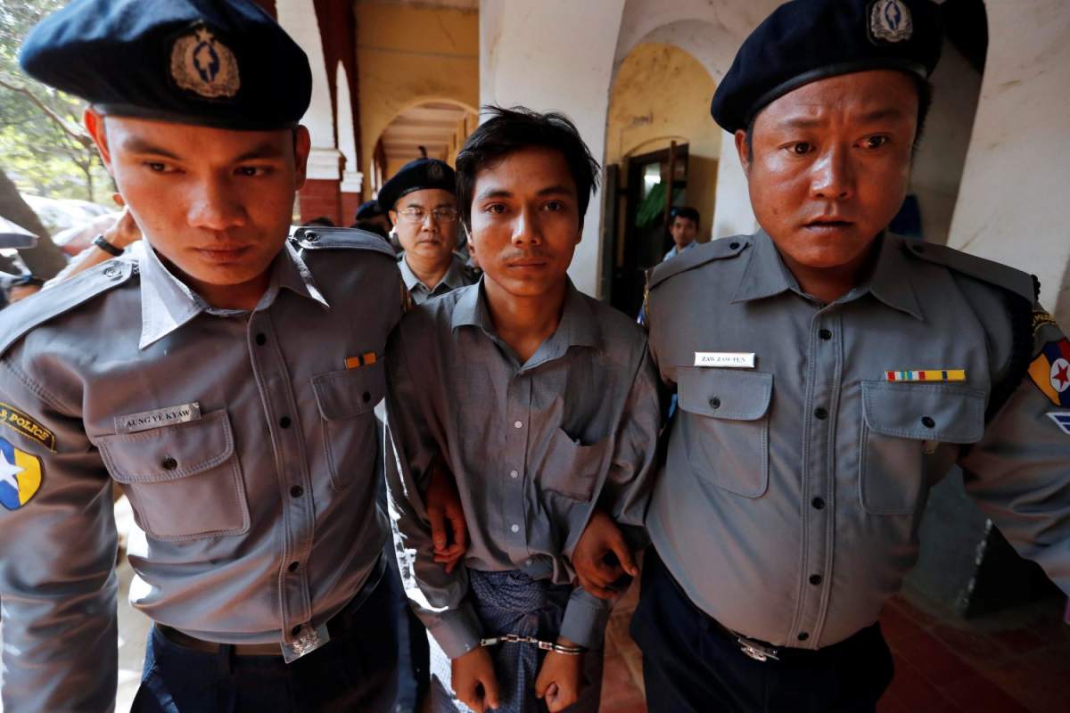 Detained Reuters journalist Kyaw Soe Oo is escorted by police after a court hearing in Yangon, Myanmar February 1, 2018.