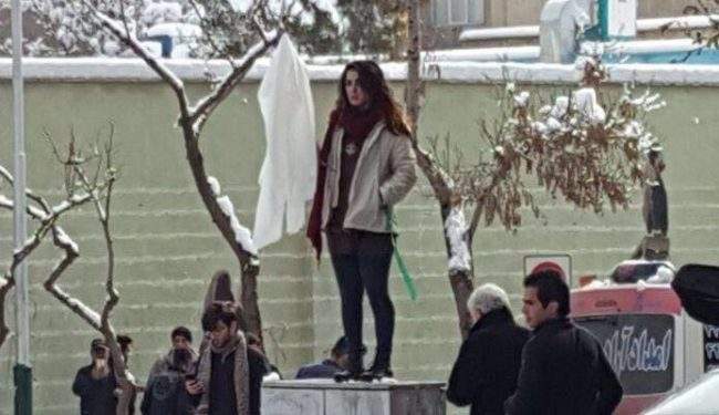 Protester Narges Hosseini holds up her white headscarf to protest Iran’s mandatory hijab laws, in this undated photo.
