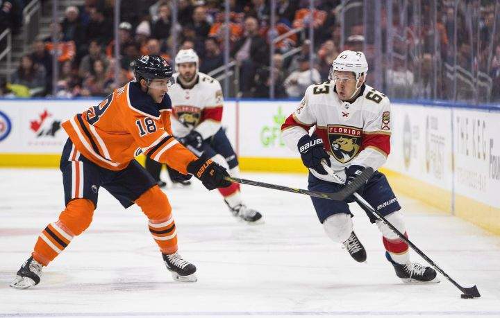 Florida Panthers right wing Evgenii Dadonov (63) and Edmonton Oilers centre Ryan Strome (18) battle for the puck during first period NHL action in Edmonton, Alta., on Monday February 12, 2018. 