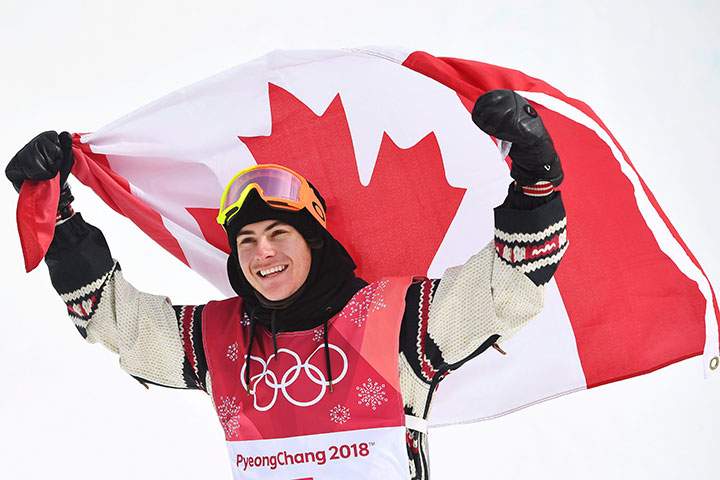 Gold medallist Sebastien Toutant celebrates following the men's snowboard big air final at the 2018 Winter Olympic Games in Pyeongchang, South Korea, Feb. 24, 2018. 