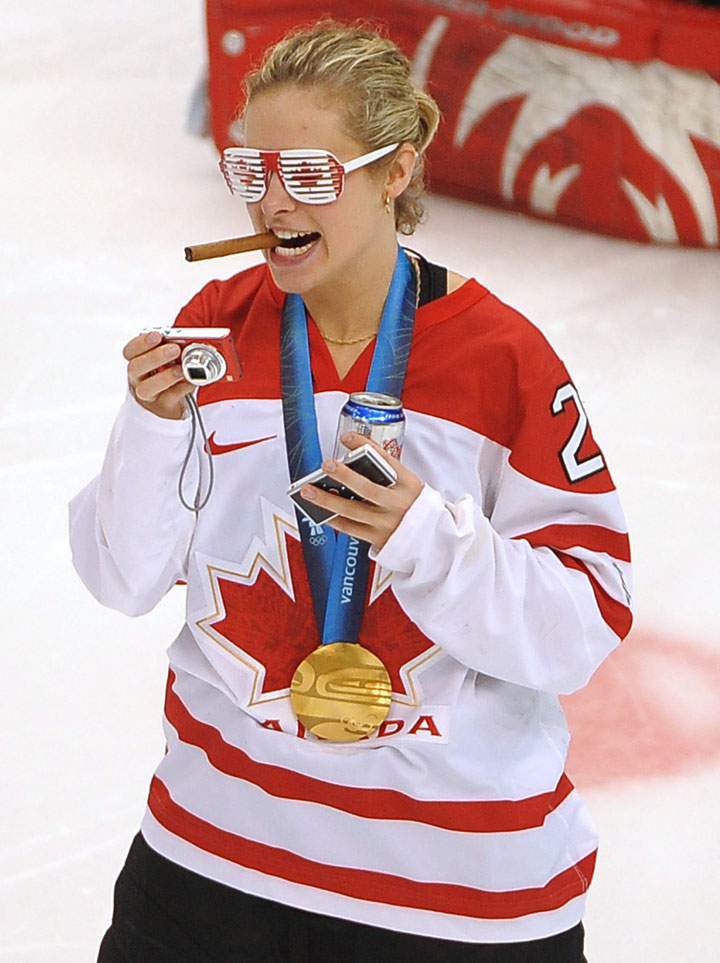 Canada’s Tessa Bonhomme wears Canadian flag glasses and smokes a cigar as she celebrates on the ice with teammates after Canada defeated the USA 2-0 in the Women’s Olympic hockey gold medal game at Canada Hockey Place Thursday Feb. 25, 2010 at the 2010 Vancouver Olympic Winter Games.