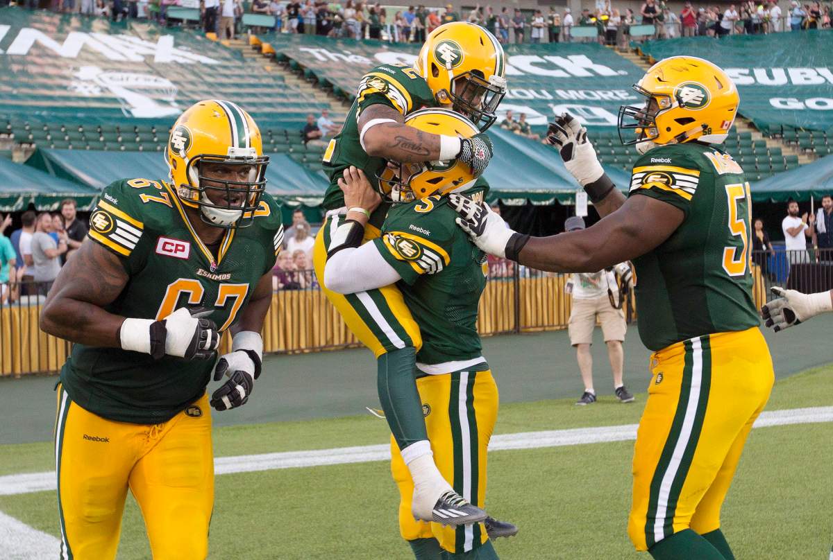 Edmonton Eskimos' D'Anthony Batiste (67), Kendial Lawrence (32), quarterback Jordan Lynch (5) and Tony Washington (58) celebrate a touchdown against the Ottawa Redblacks during second half action in Edmonton, Alta., on Thursday July 9, 2015. 