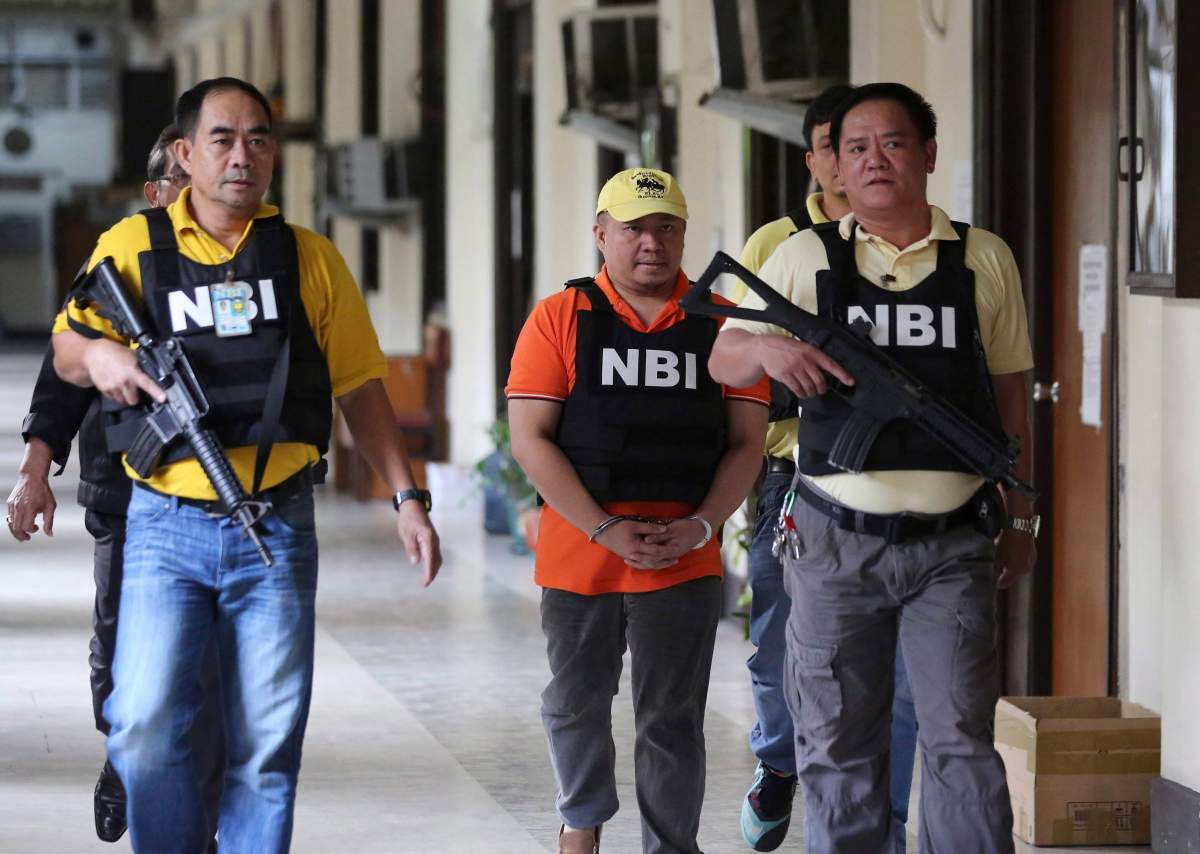 Russell Salic, center, a Filipino doctor accused by U.S. authorities of plotting attacks in New York City with Canadian Abdulrahman El-Bahnasawy. (AP Photo/Aaron Favila)