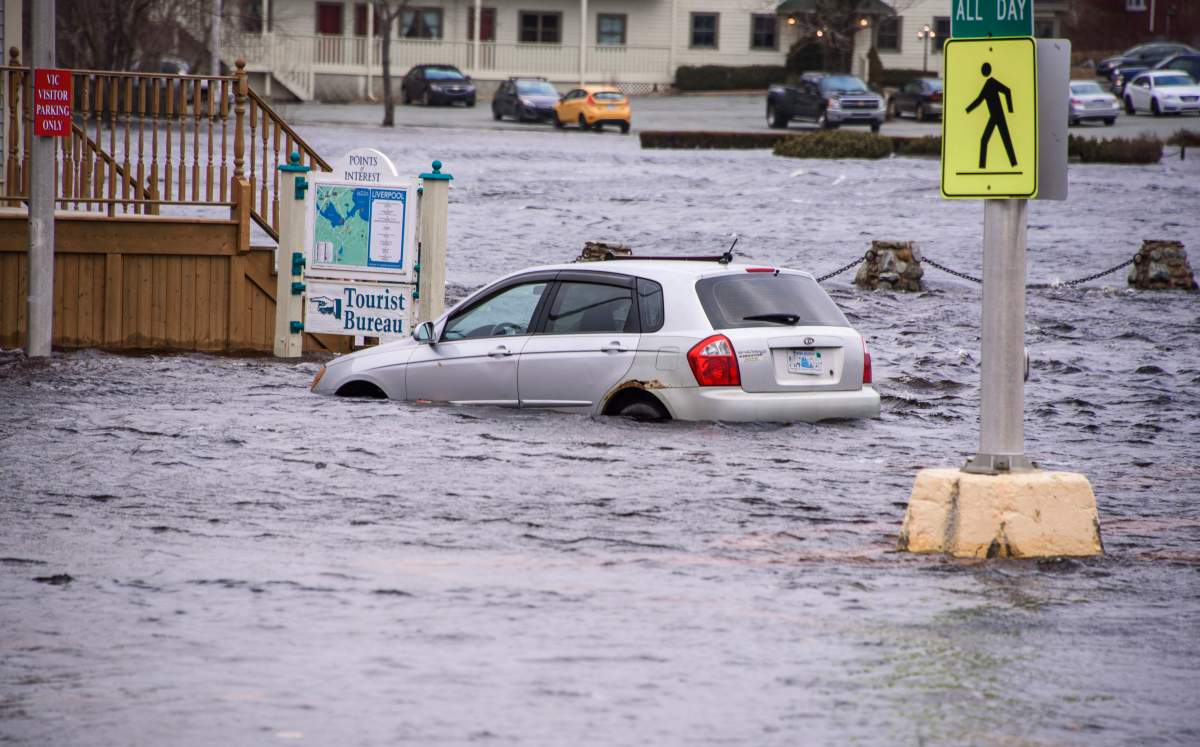 A car sits in sea water up to it's wheel wells at a tourist bureau in Liverpool, Nova Scotia on Saturday March 3, 2018. After another weekend of storm surges battering Nova Scotia's south shore, there're rising concerns from some municipal politicians and citizens about the need for help adapting to climate change. 