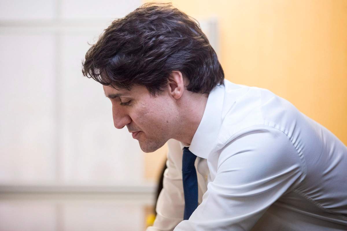 Prime Minister Justin Trudeau talks to clients and staff during a visit to the Employment Services Centre of WoodGreen Community Services in Toronto on Wednesday March 7, 2018. 