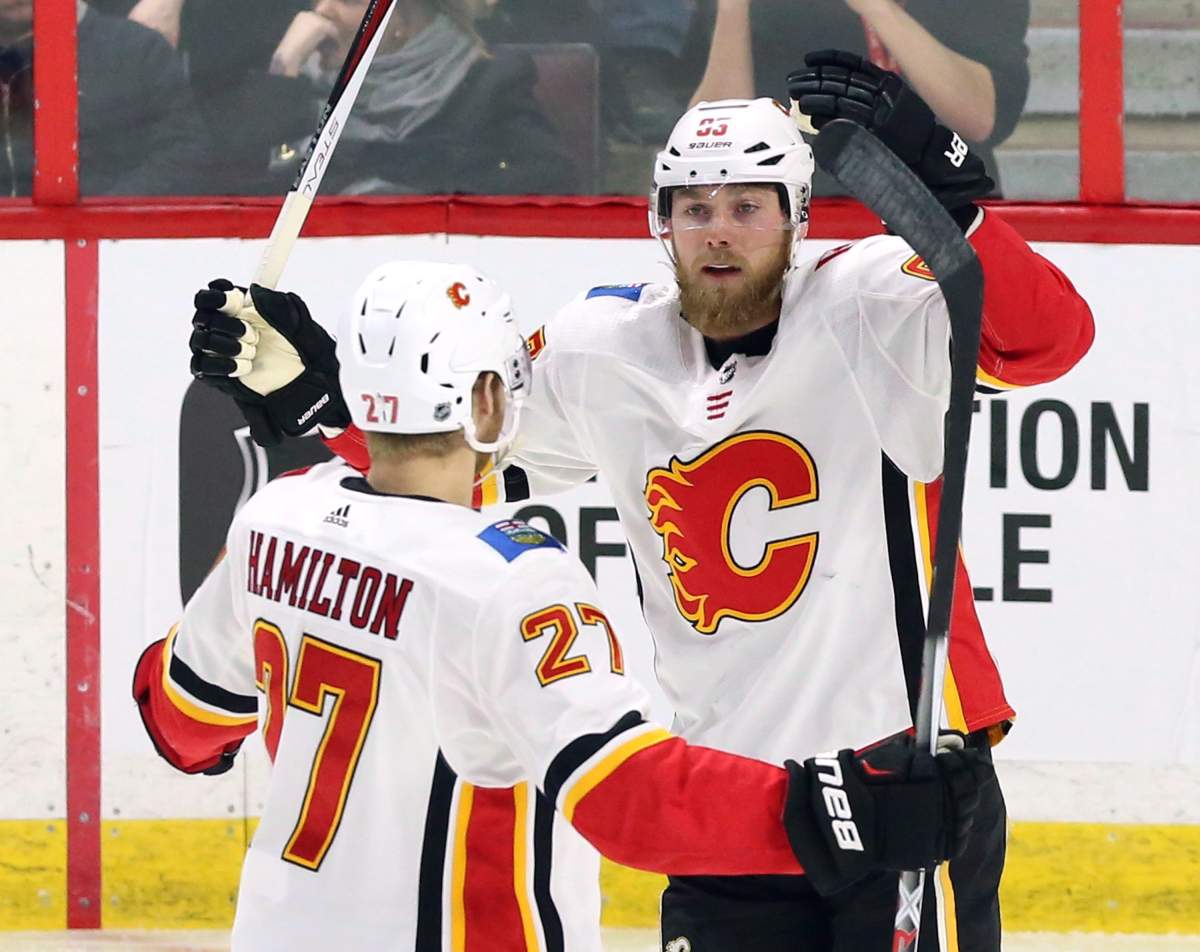 Calgary Flames centre Sam Bennett (93) celebrates his goal against the Ottawa Senators with defenceman Dougie Hamilton (27) during first period NHL hockey action in Ottawa on Friday, March 9 2018. THE CANADIAN PRESS/Fred Chartrand.