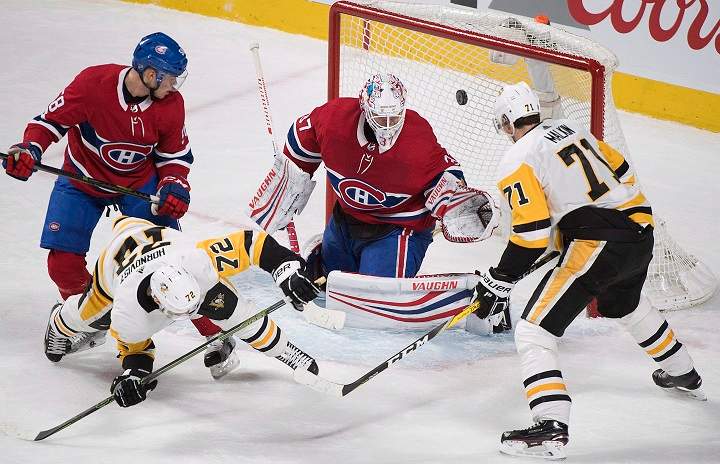 Pittsburgh Penguins right wing Patric Hornqvist (72) scores against Montreal Canadiens goaltender Antti Niemi (37) as Penguins centre Evgeni Malkin (71) and Canadiens defenceman Noah Juulsen (58) look for the rebound during third period NHL hockey action in Montreal, Thursday, March 15, 2018. 