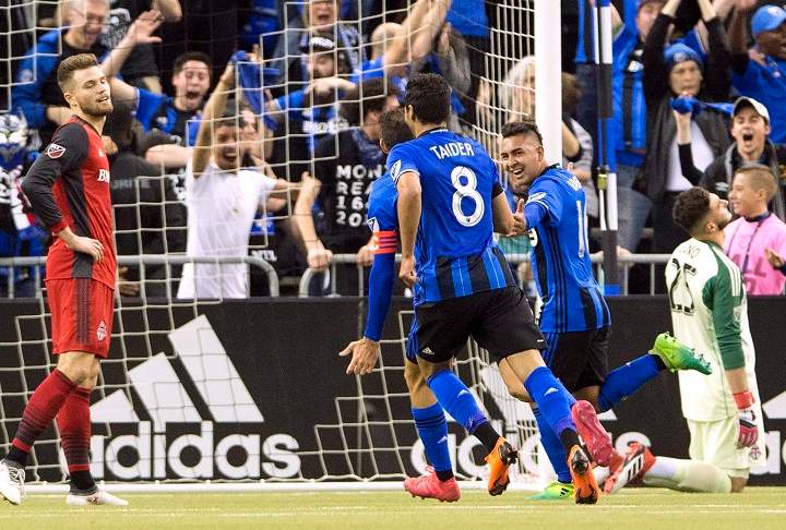 Montreal Impact midfielder Ignacio Piatti (10) celebrates with teammates as Toronto FC goalkeeper Alex Bono right, and Toronto FC forward Eriq Zavaleta, left, look on after scoring the first goalduring first half MLS action in Montreal on Saturday, March 17, 2018. 