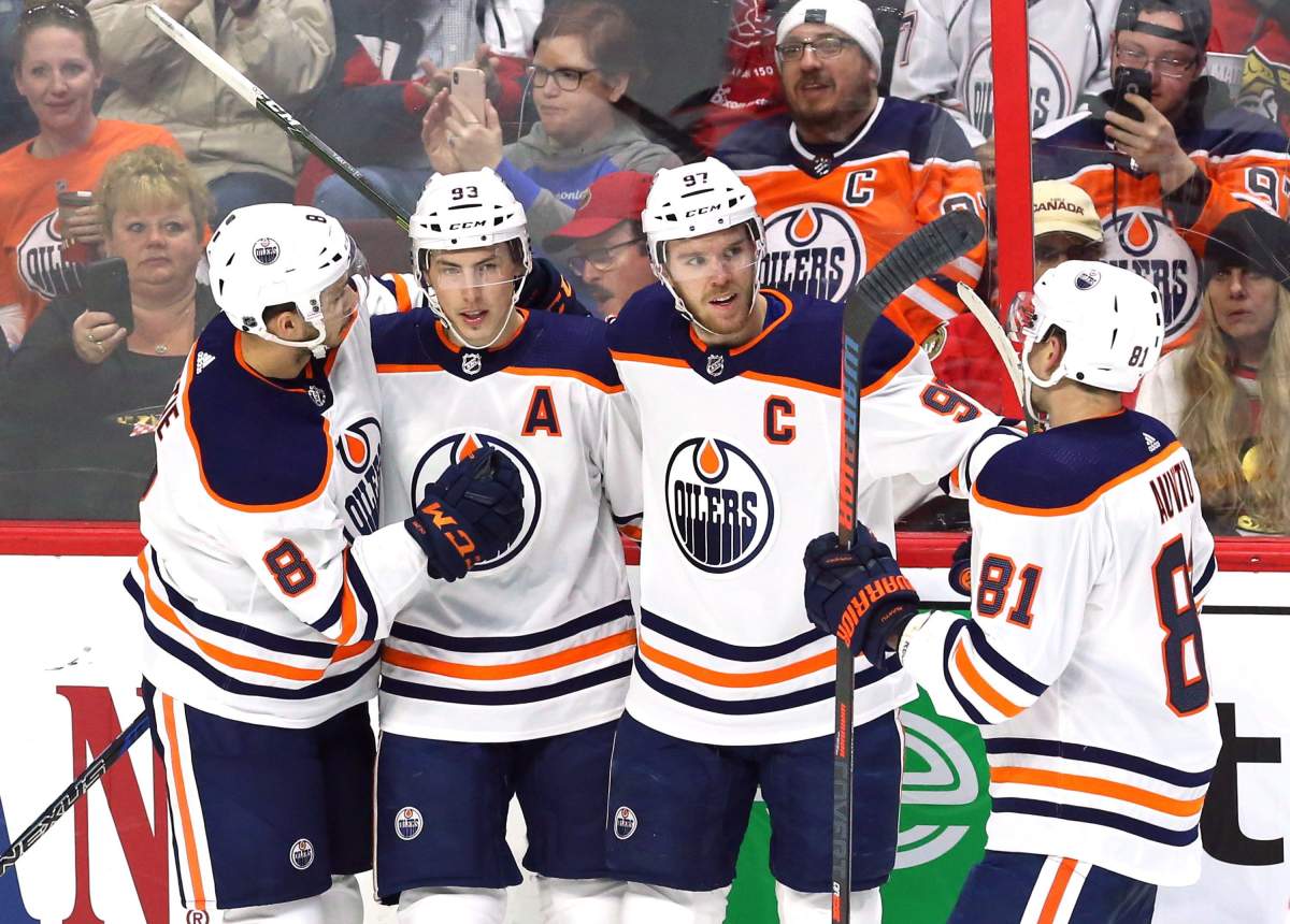 Edmonton Oilers centre Connor McDavid (97) celebrates his goal against the Ottawa Senators with right wing Ty Rattie (8) centre Ryan Nugent-Hopkins (93) and defenceman Yohann Auvitu (81) during second period NHL hockey in Ottawa on Thursday, March 22, 2018. 
