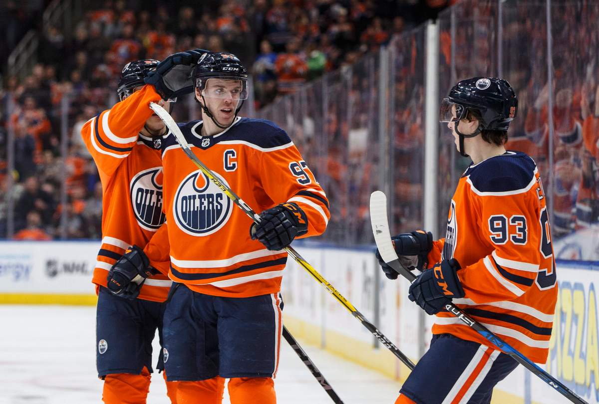 Edmonton Oilers' Matthew Benning (83), Connor McDavid (97) and Ryan Nugent-Hopkins (93) celebrate McDavid's goal against the Los Angeles Kings during second period NHL action in Edmonton, Alta., on Saturday, March 24, 2018. THE CANADIAN PRESS/Jason Franson.