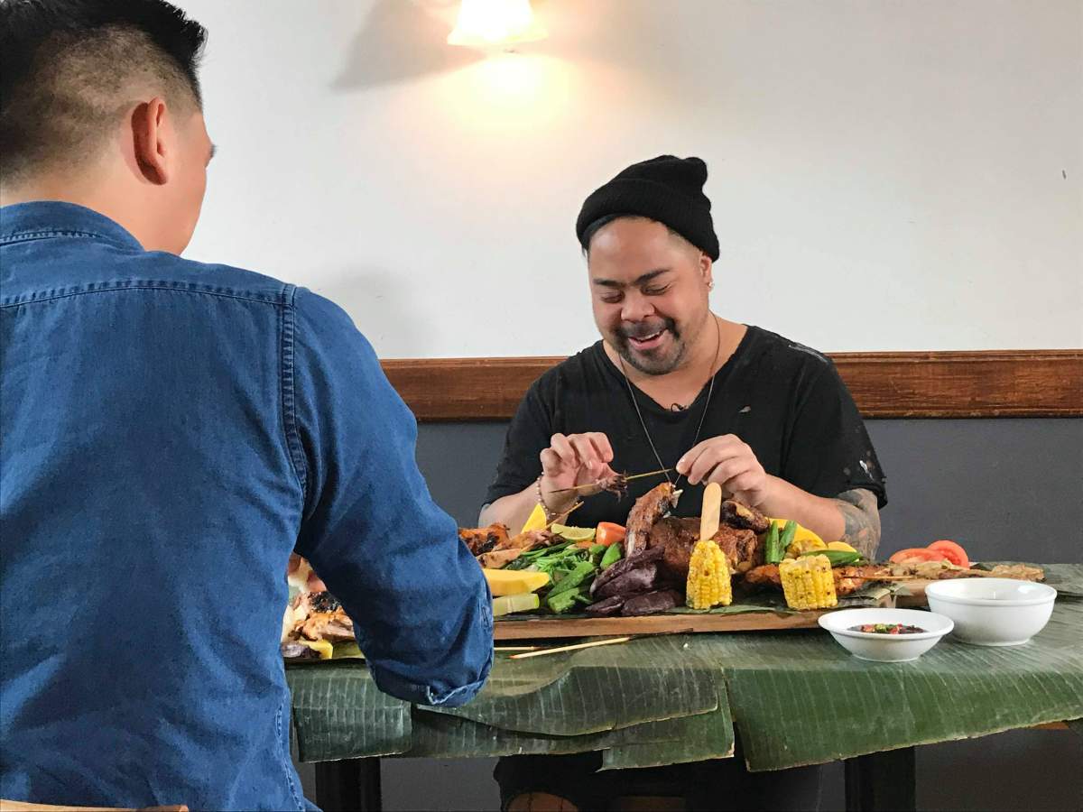 Pierre Anthony Garque shares a kamayan with Mark Sy, co-owner of Kawali Restaurant in Montreal, Sun. March 4, 2018.