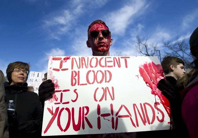 Connor Feliu of Syracuse N.Y., covered in red paint, attends the “March for Our Lives” rally in support of gun control in Washington, Saturday, March 24, 2018, on Pennsylvania Avenue near the U.S. Capitol. (AP Photo/Jose Luis Magana)