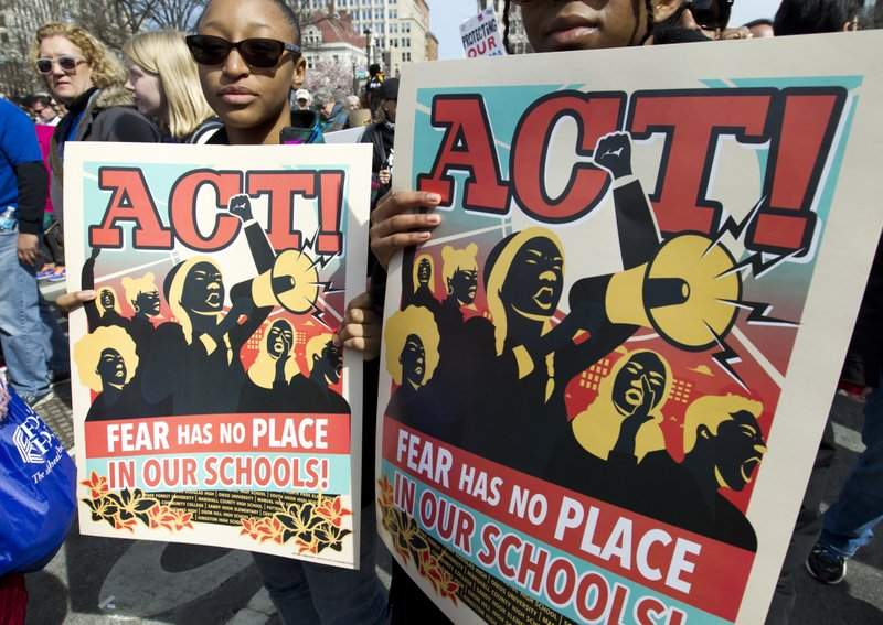 Protesters hold signs during the “March for Our Lives” rally in support of gun control in Washington, Saturday, March 24, 2018, on Pennsylvania Avenue near the U.S. Capitol. (AP Photo/Jose Luis Magana)
