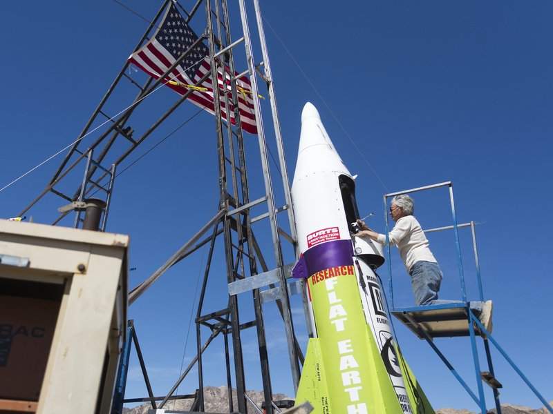 In this March 6, 2018, file photo, “Mad” Mike Hughes begins work on repairing a steam leak after he scrubbed his launch attempt of his steam-powered rocket near Amboy, Calif. – James Quigg/Daily Press via AP, File