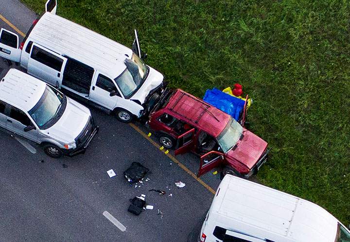 Officials investigate near a vehicle where a suspect in the deadly bombings that terrorized Austin blew himself up as authorities closed in on him, in Round Rock, Texas, March 21, 2018.