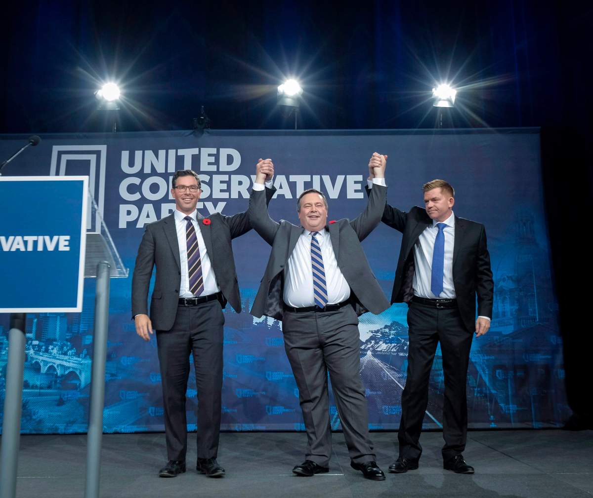 Brian Jean Jason Kenney, centre, celebrates his victory as the first official leader of the Alberta United Conservative Party with his opponents Brian Jean, right, and Doug Schweitzer in Calgary, Alta., Saturday, Oct. 28, 2017.