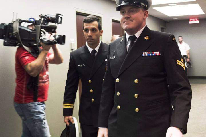 FILE – Accused Master Seaman Daniel Cooper, right, arrives for his standing court martial case.
