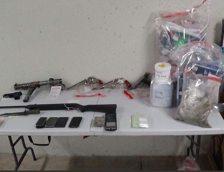 Police seized drugs and several replica firearms, and a submachine gun in the raid.