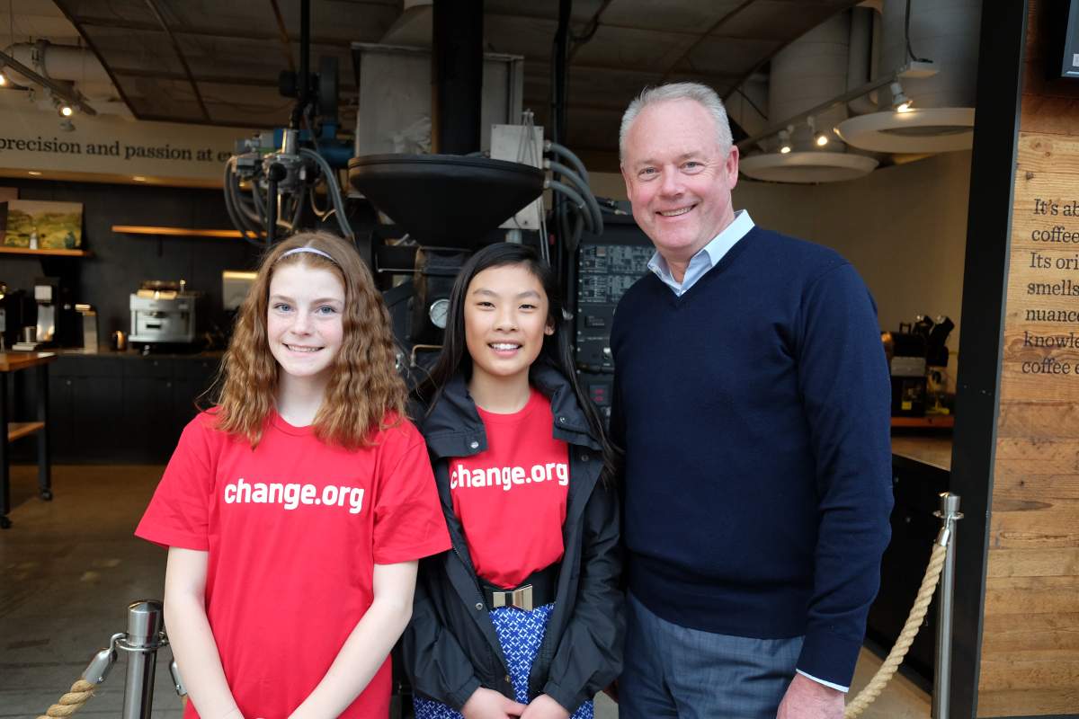 Eve Helman (left) and Mya Chau meet Starbucks CEO Kevin Johnson in Seattle.
