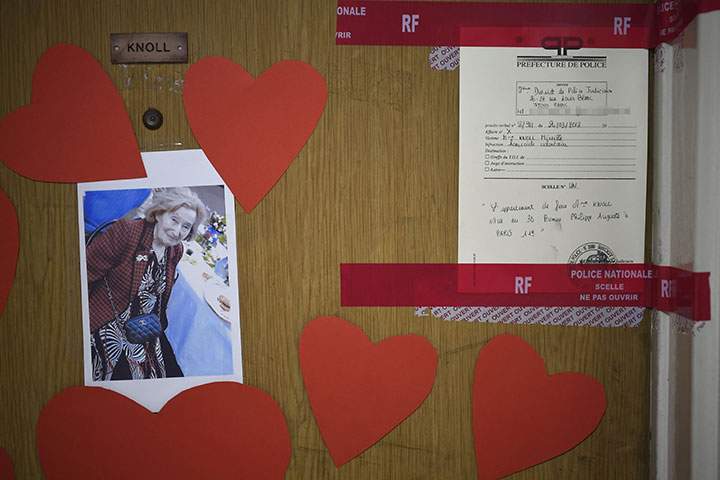 A picture taken on March 27, 2018 shows a photograph of Mireille Knoll, and police documents sealing the door seals to her apartment in Paris.