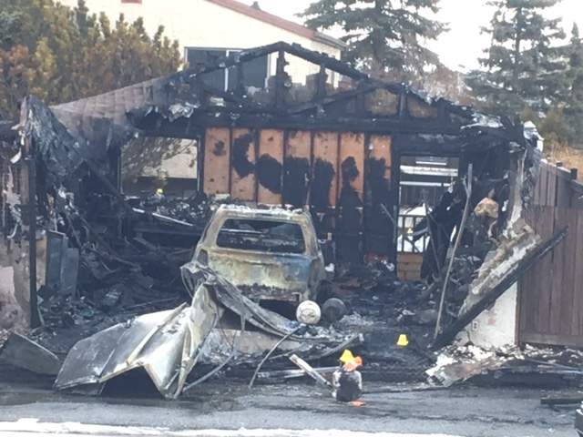 The burned out garage where a man was found dead Tuesday, March 27, after an officer was shot in Abbeydale.