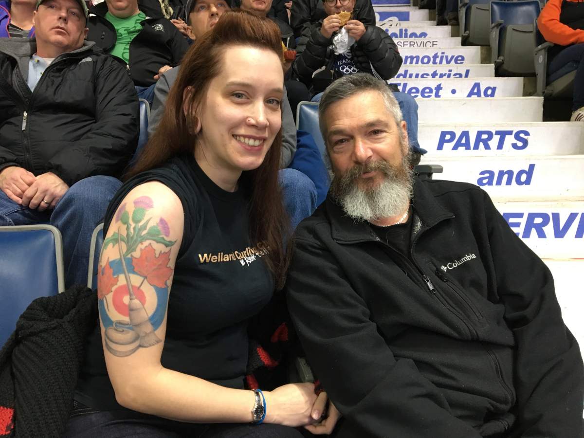 Sheila McNulty (lefts) rolls up her sleeve at to show off her curling tattoo she got nine years ago.
