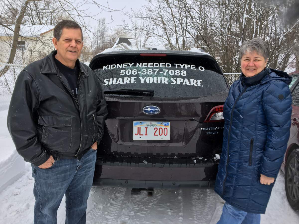 Dan McLaughlin and Pat McLaughlin pose with the decal that they hope will find a matching donor that will be willing to donate their kidney.