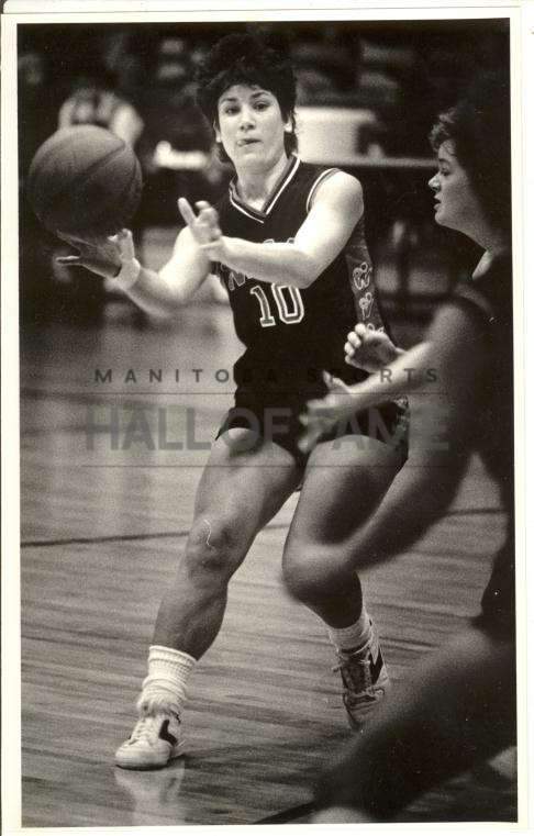 Jill Mathez in action with the U of W Wesmen Women\’s Basketball team