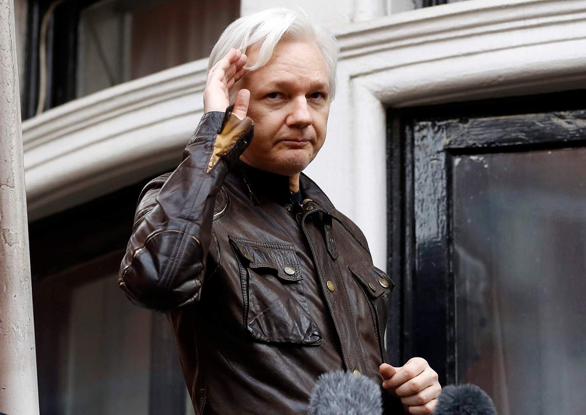 In this May 19, 2017 file photo, WikiLeaks founder Julian Assange greets supporters from a balcony of the Ecuadorian embassy in London.