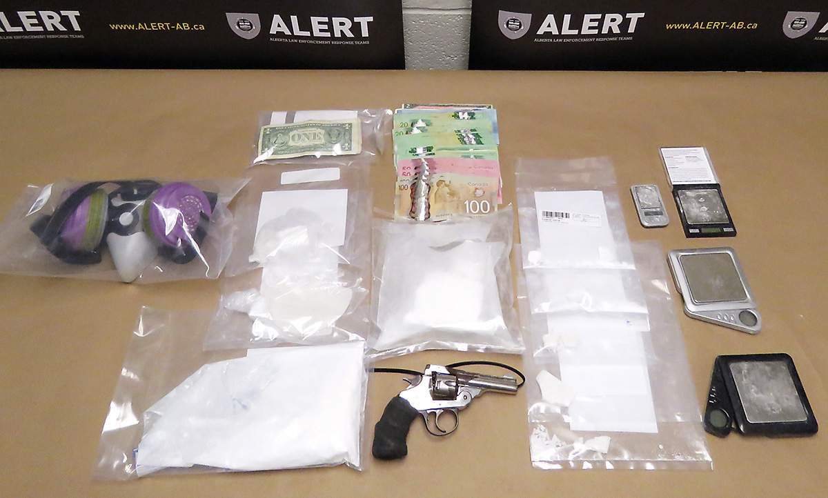 Drugs and weapons police say they seized from a Lethbridge, Alta. apartment on March 27, 2018 are displayed.