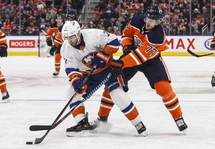 New York Islanders’ Jordan Eberle (7) and Edmonton Oilers’ Oscar Klefbom (77) battle for the puck during first period NHL action in Edmonton, Alta., on Thursday March 8, 2018.