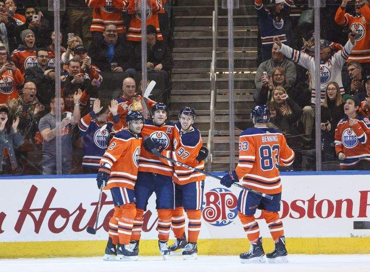 Edmonton Oilers’ Andrej Sekera (2), Milan Lucic (27), Connor McDavid (97) and Matthew Benning (83) celebrate a goal against the Arizona Coyotes during first period NHL action in Edmonton, Alta., on Monday March 5, 2018.