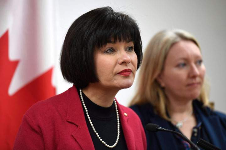 Minister of Health Ginette Petitpas Taylor listens to a question during an announcement on funding for the opioid crisis, as Liberal MP for Ottawa-Vanier Mona Fortier looks on, in Ottawa on Monday, March 26, 2018. The government is making it easier for patients to access prescription heroin and methadone in its fight against the opioid crisis.
