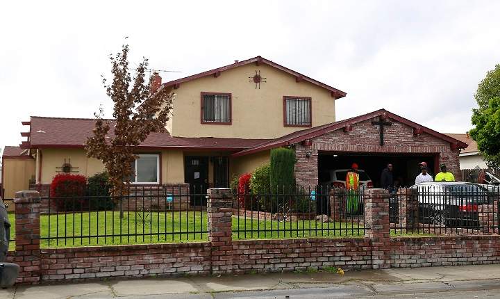 People gather outside the home, Wednesday, March 21, 2018, where Stephon Alonzo Clark, 22, was shot and killed by a pair of Sacramento Police officers in Sacramento, Calif.
