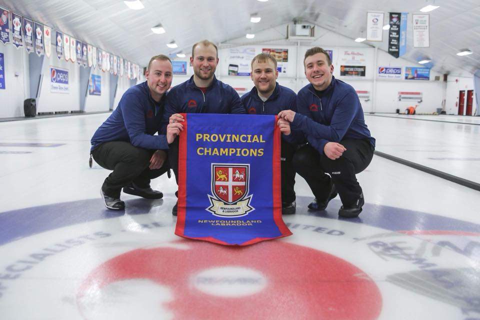 Team Smith poses with Newfoundland and Labrador’s provincial banner—the first team that isn’t Team Gushue to represent the maritime province since 2006. L-R lead Ian Withycombe, second Andrew Taylor, third Matthew Hunt and skip Greg Smith.