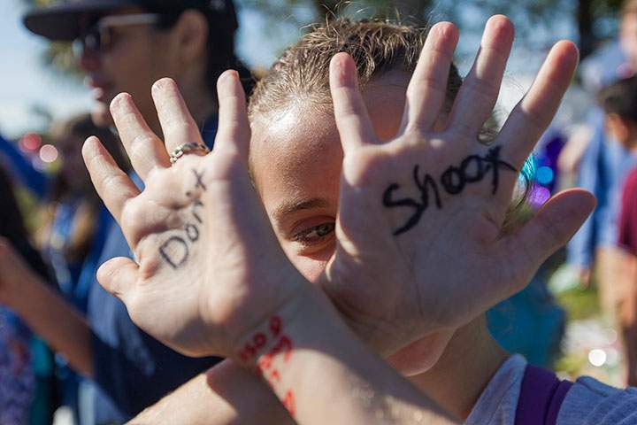 A Grade 6 student participates in a walkout to protest gun violence, Wednesday, Mar. 14, 2018, in Parkland, Fla., one month after the deadly shooting at nearby Marjory Stoneman Douglas High School.