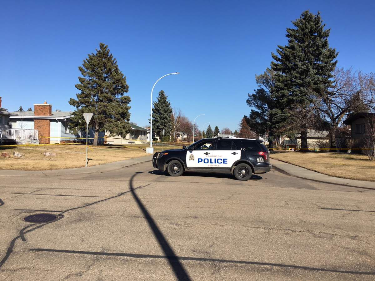 Edmonton police block off two homes and an alley near 79 Street and 143 Avenue April 23, 2018.